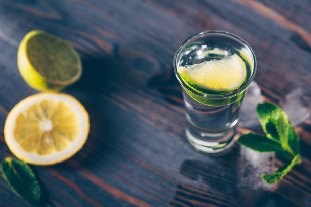 Alcoholic still-life, vodka, gin, tequila in a glass with ice - Valokuva, kuva