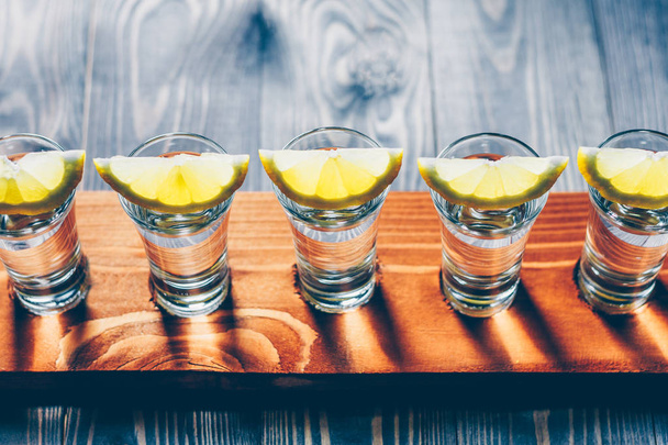 vodka shot with lemon on the board for guests of the party - Photo, image