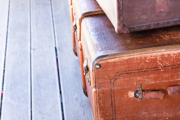 brown pair suitcases close-up wooden background. vintage weathered - Photo, Image