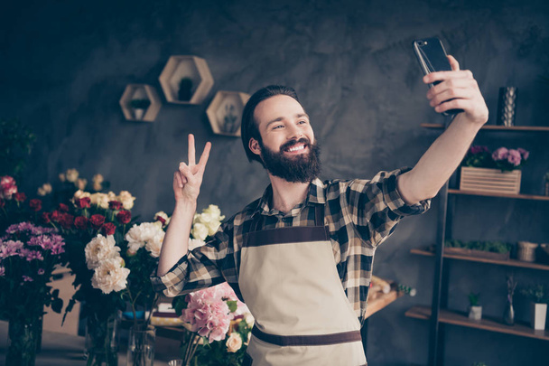 Portrait of charming attractive sweet self-employed people entrepreneur person hold hand modern technology camera content enjoy rest free time occupation hobby make v-sign wear checked shirt - Photo, Image
