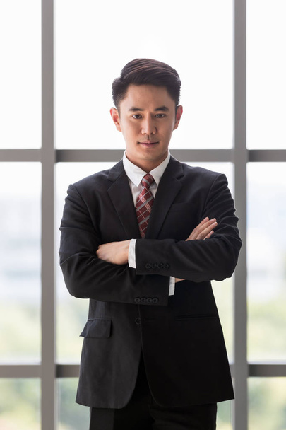 Businessman standing and crossed his arm - 写真・画像