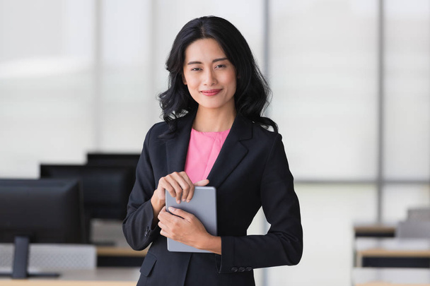 Businesswoman holds tablet computer in office - Photo, Image