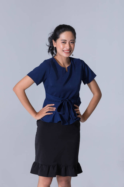 Asian businesswoman standing and akimbo - Photo, Image