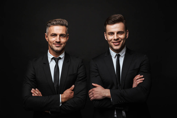 Two confident handsome businessmen wearing suit - Fotó, kép