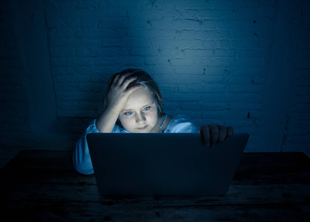 Scared sad girl bullied online on laptop suffering cyber bullying harassment. School girl humiliated on the internet by classmates feeling desperate and intimidated. Children victim of bullying. - Zdjęcie, obraz