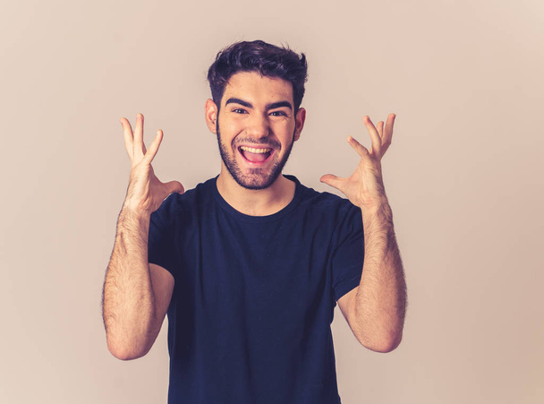 Portrait of young man celebrating achieving his goal, wining the lottery or having great success in face expression human emotions and surprised and happy facial expression isolated on grey. - Foto, Bild