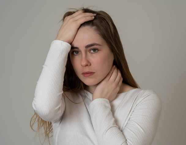 Portrait of young sad teenager girl feeling lonely and distressed suffering from depression looking hopeless and suicidal. Feeling sorrow and fear. In People, emotions and adolescent mental health. - Fotoğraf, Görsel