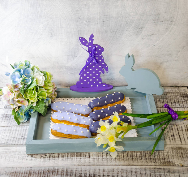 Easter decoration set with glazed kulich and vanilla eclairs - 写真・画像