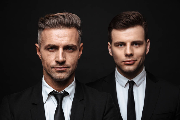 Two confident handsome businessmen wearing suit - Fotó, kép