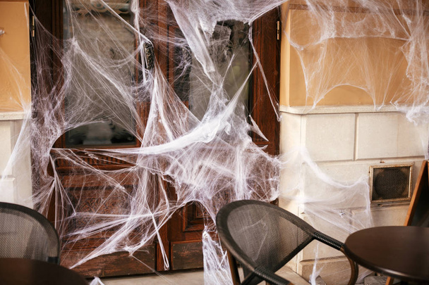Spooky spider web on building facade in city street, holiday dec - Foto, imagen