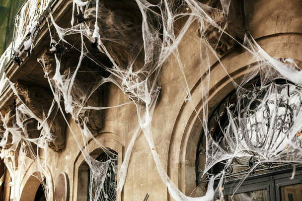 Halloween street decor. Spooky spider web on building facade in  - Photo, Image
