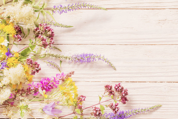 wildflowers on white wooden background  - Фото, зображення