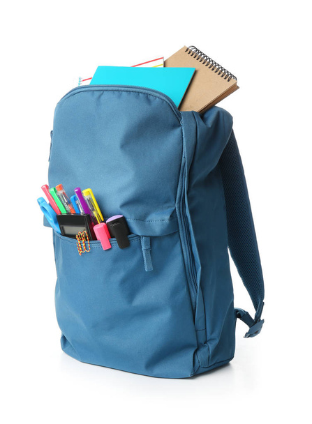 School backpack with stationery on white background - Фото, изображение