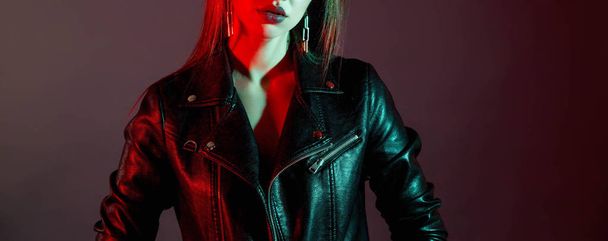 Girl in a leather jacket in the studio with color filters - Photo, image