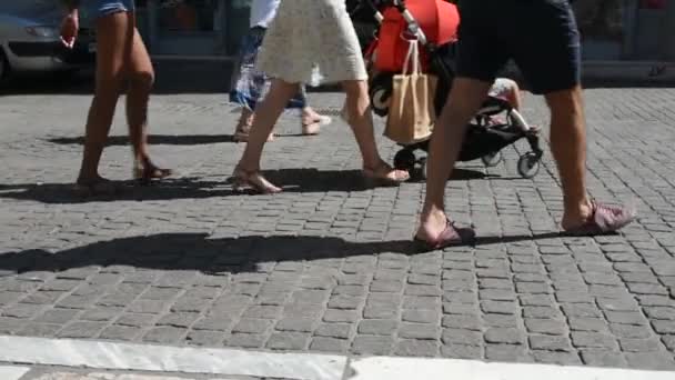 legs of people walking in multiple directions on a sunny day in slow motion - 映像、動画