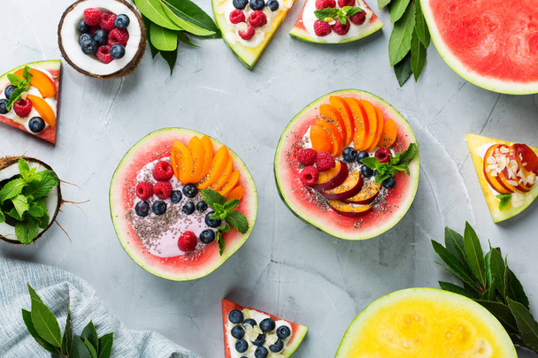 Healthy summer breakfast with fruit salad and yogurt in watermelon - Fotó, kép