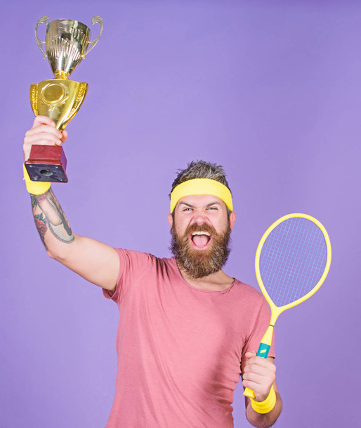 Celebrate victory. Tennis champion. Athletic man hold tennis racket and golden goblet. Win tennis game. Tennis player win championship. Man bearded successful athlete. First place. Sport achievement - Photo, Image