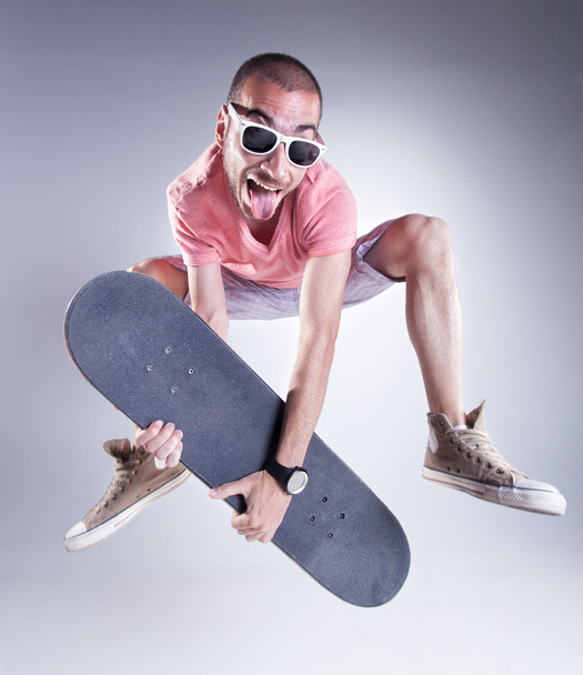 crazy guy with a skateboard making funny faces - Foto, imagen