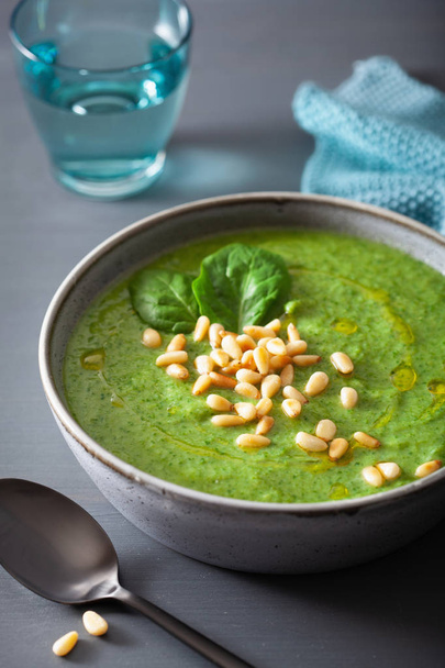 green creamy cauliflower spinach soup on gray background - Foto, imagen