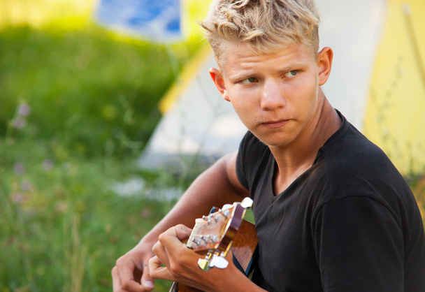 Young man plaing by guitar - Photo, Image