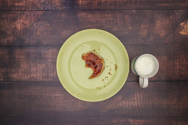 Jam on the bread and cup of milk on the table for breakfast - 写真・画像