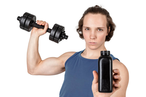 Handsome young man in blue shirt lifting dumbbell. White background isolated - Foto, Bild