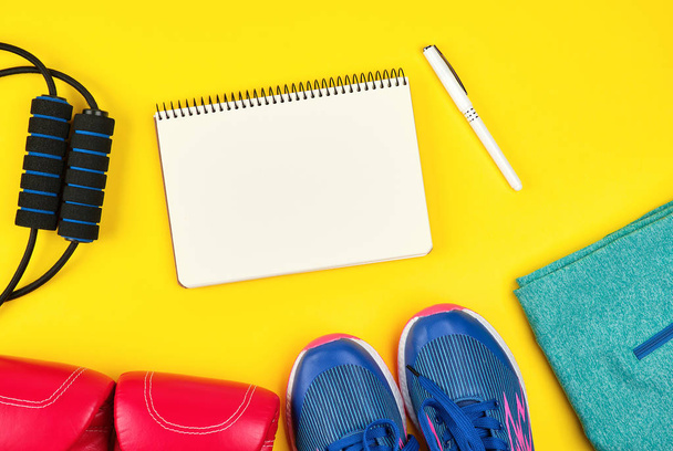 open empty notebook and sports women's clothing for sports and f - 写真・画像
