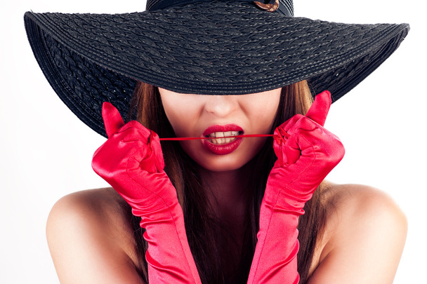 Woman in a hat and red gloves - 写真・画像