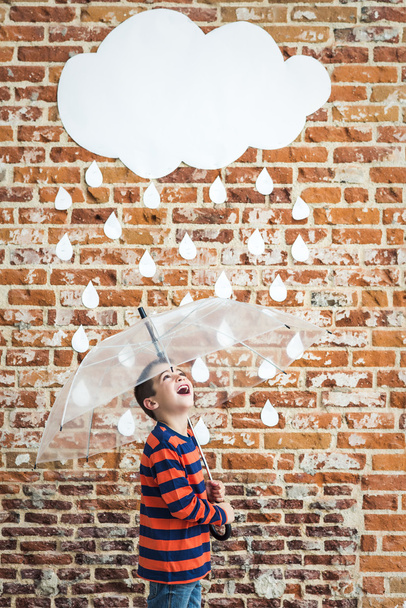 Little Child under White Cardboard Raindrops - 写真・画像