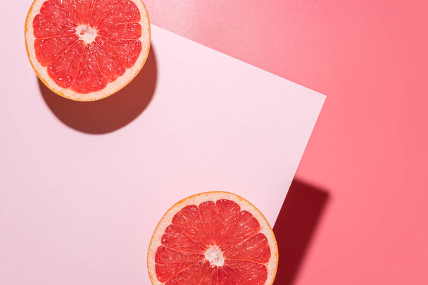 Creative fruit composition on pink background with hard shadows. - Fotoğraf, Görsel