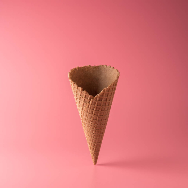 Ice cream cone on pink background. Minimal summer concept. - Photo, Image