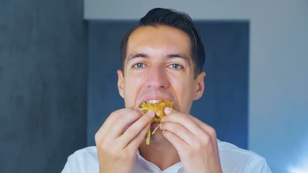 Businessman eating a hamburger. Fast food. Cheeseburger, hamburger, sandwich. - Footage, Video