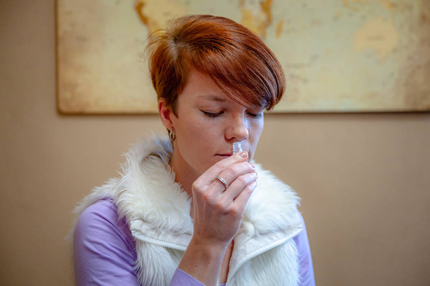 woman tests and recognizes the smell on lectures about natural smells - Photo, Image
