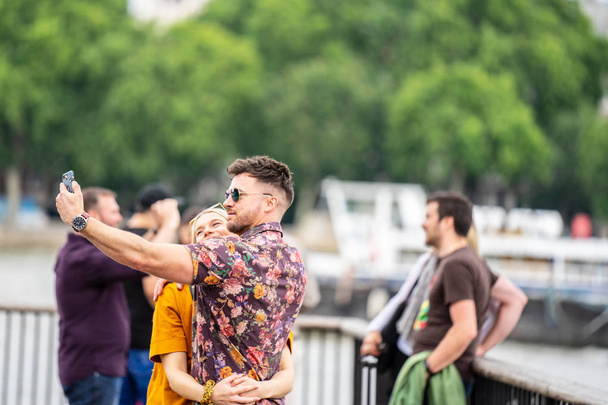 London, UK, July, 2019. Close up portrait of happy attractive couple taking selfie in London - Photo, Image