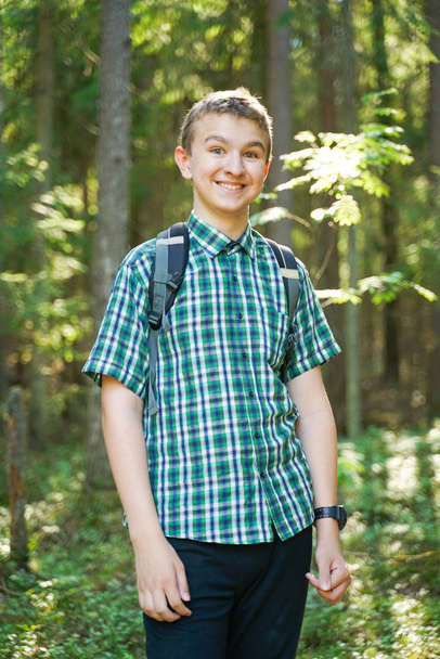 teenager boy walking in the forest alone in the summer day - Foto, imagen