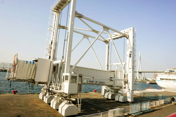 Yacht passenger gangway telescopic (boarding bridge) for pick up and drop off yacht passengers at Osaka port on bright blue sky background, is the main port in Japan, located in Osaka within Osaka Bay - Photo, Image