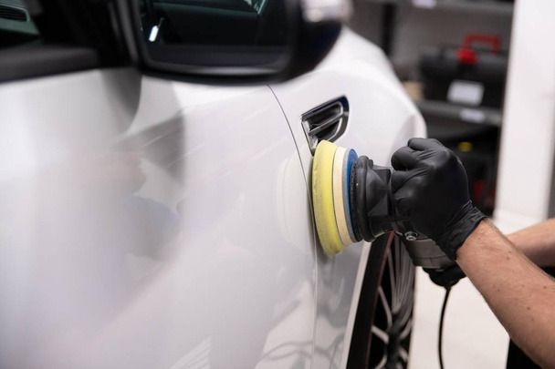 Polishing car with electric grinder - Фото, изображение