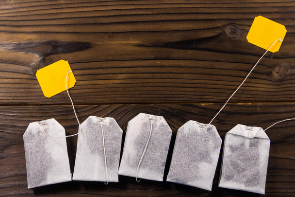 Tea bags on wooden table. Top view - Photo, Image