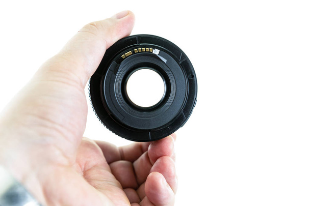 macro lens in male hands visible through the lens isolated background - Photo, Image