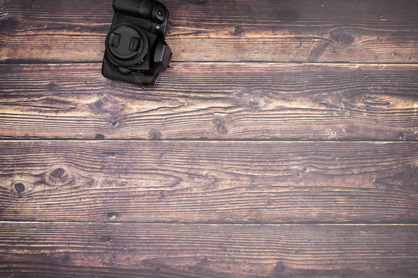 Black camera on the wooden background  - Foto, imagen