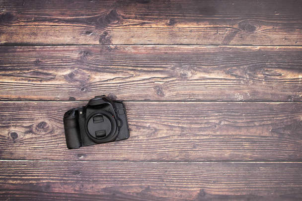 Black camera on the wooden background  - Foto, imagen