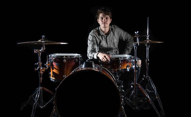 Professional drummer playing on drum set on stage on the black b - Photo, Image