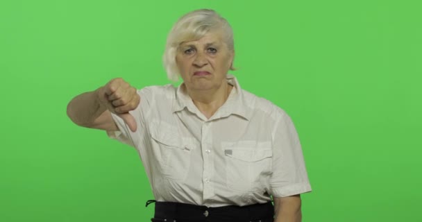 Una donna anziana che mostra no e dà il pollice verso il basso. Nonna. Chiave cromatica
 - Filmati, video