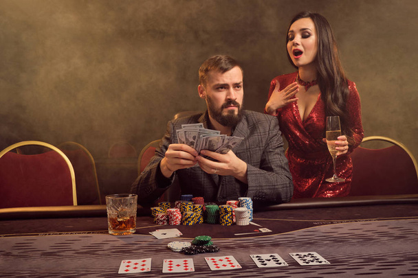 Чарівна багата пара грає в покер в казино
. - Фото, зображення