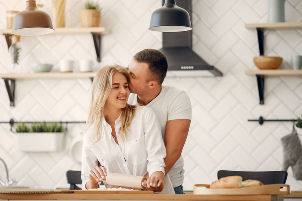 Beautiful couple prepare food in a kitchen - Fotoğraf, Görsel