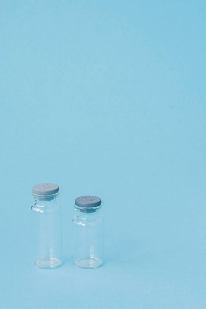 Vial of medicine on blue background with copy space. Antibiotic  - Zdjęcie, obraz