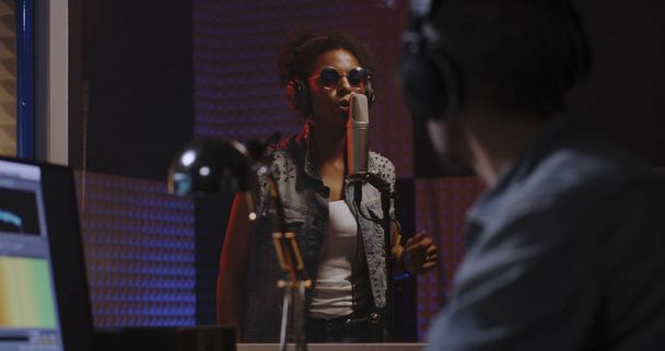 Vocalista e ingeniero de sonido trabajando en estudio
 - Foto, Imagen