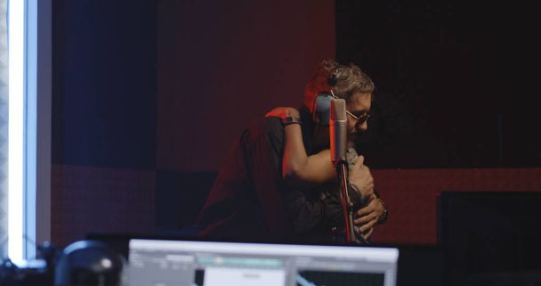 Singers and sound engineer working in studio - Photo, Image