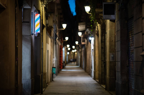 Blurred downtown alley at night with barbershop or hairdresser's - Photo, Image