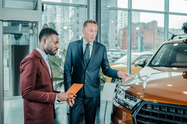Serious businessman choosing a new suitable car. - Photo, Image